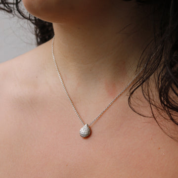 organic silver pebble pendant worn on model