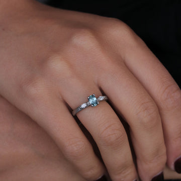 Platinum Ring with a Blue Sapphire and Marquise Cut Diamonds