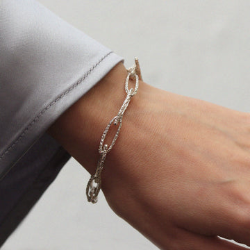 textured silver link bracelet worn on wrist