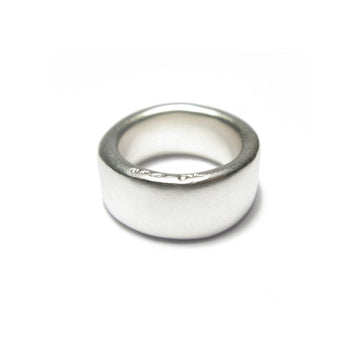 Wide plain silver band ring displayed on a white background