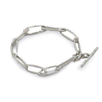 textured silver link bracelet on white background