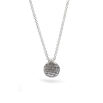 silver pebble pendant with words on white background