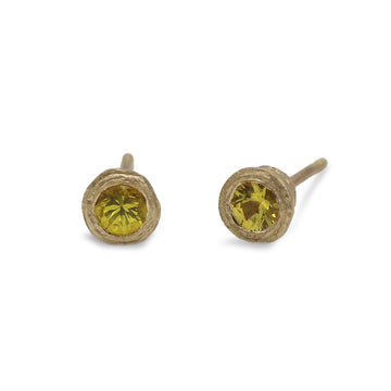 gold yellow sapphire ear studs on white background
