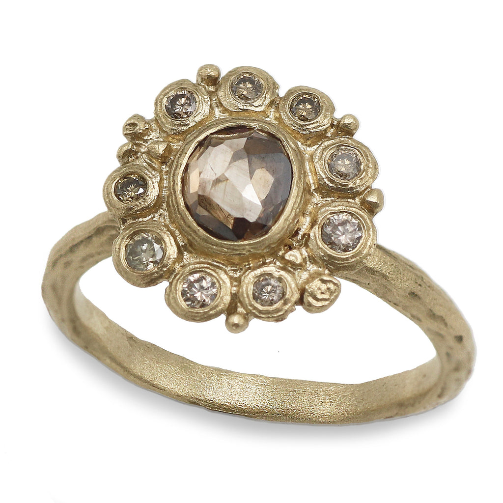 Halo brown diamond ring in yellow gold on a white background 