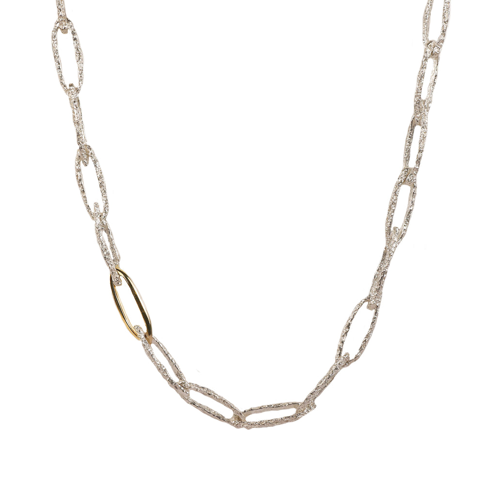 silver and gold textured link necklace on white background 