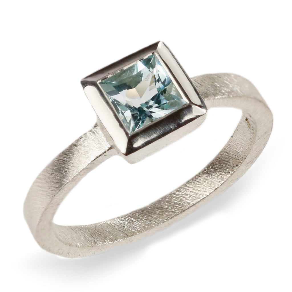 White Gold Ring with Blue Princess Cut Aquamarine  on white background 
