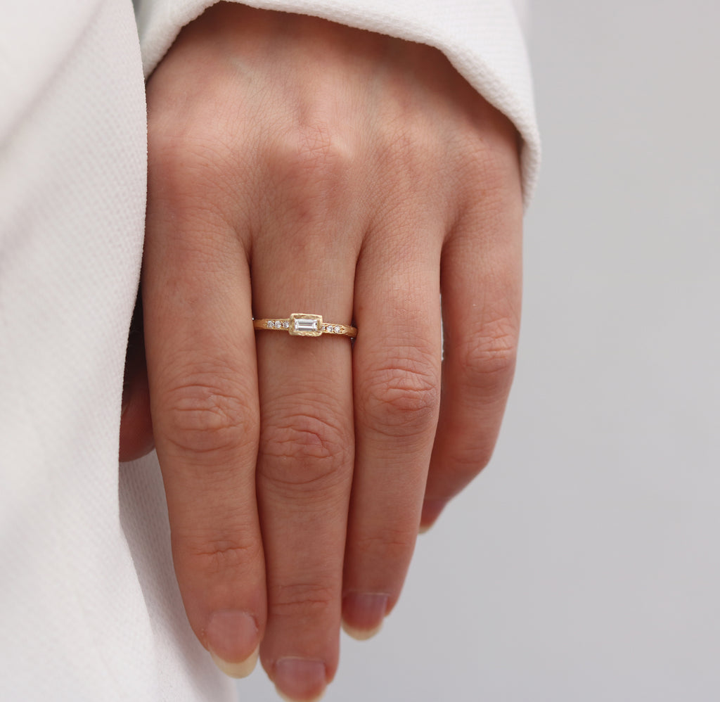 Yellow Gold Textured Ring with a Baguette and Round Diamonds