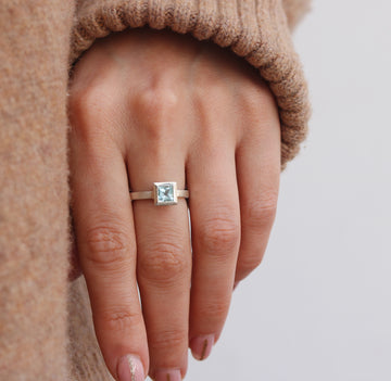 White Gold Ring with Blue Princess Cut Aquamarine worn on hand