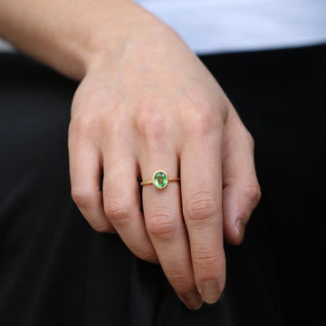 Textured Yellow Gold Ring With a Green Oval Tsavorite Garnet worn on hand