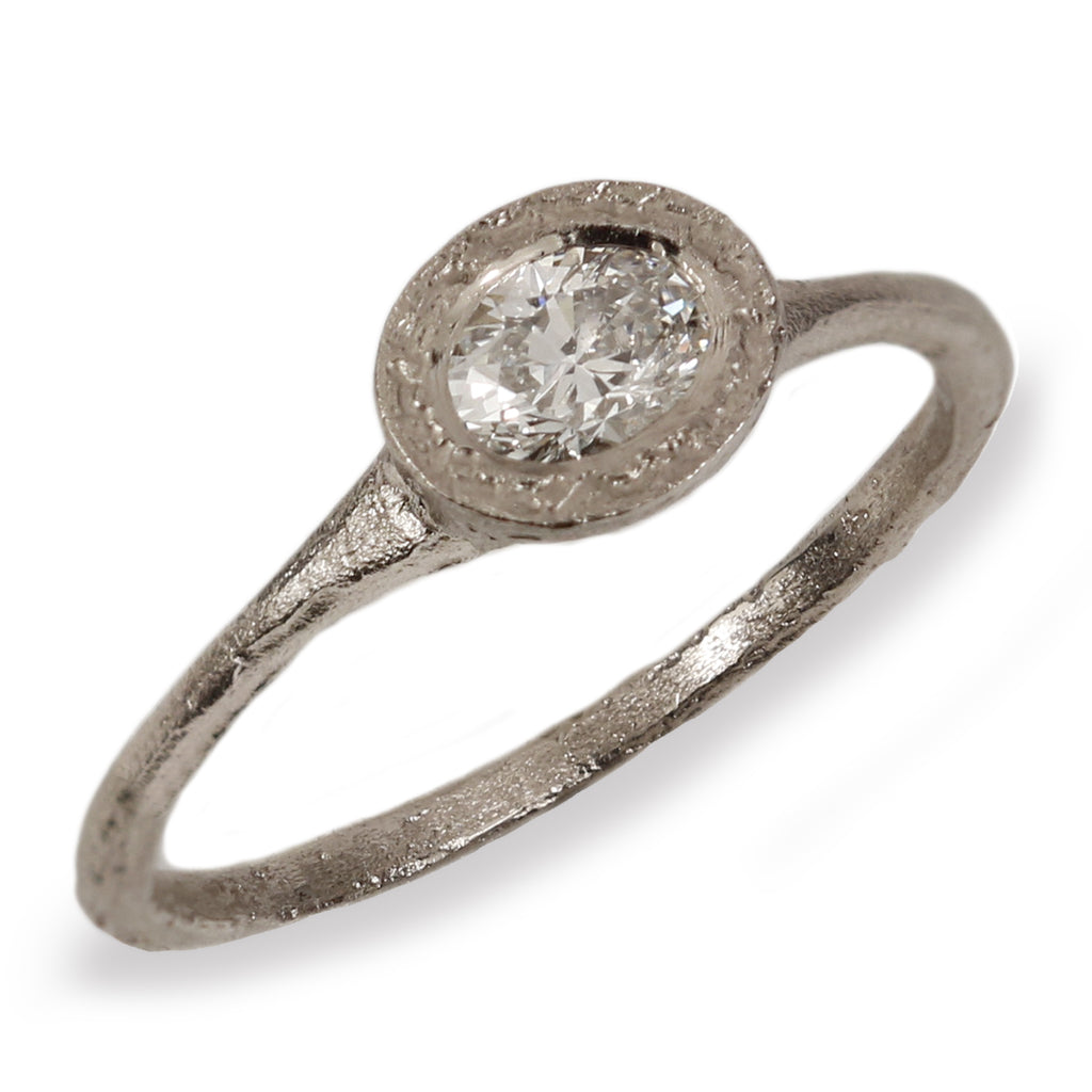 Textured White Gold Ring with Oval White Diamond on white background