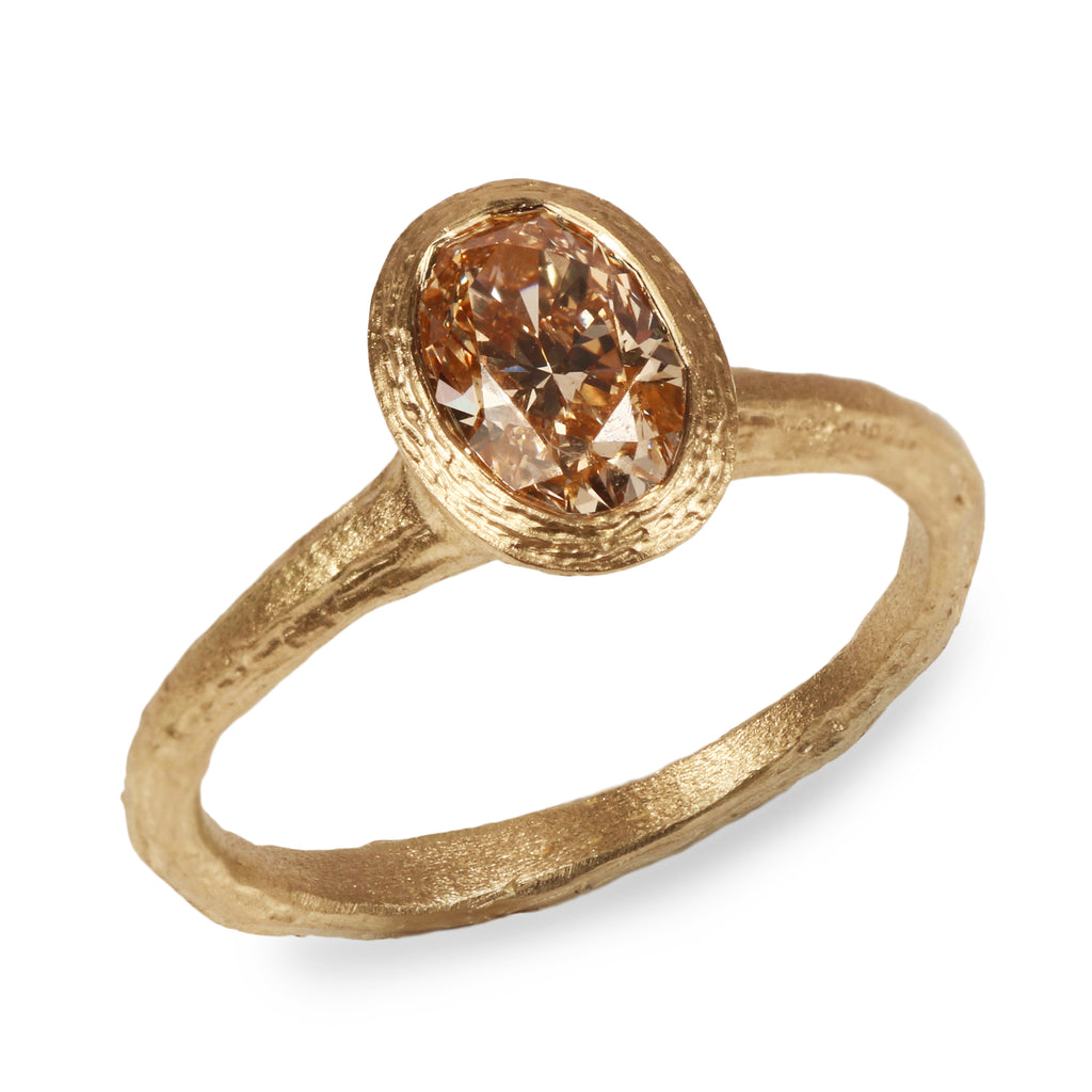 Yellow Gold Ring with Oval Champagne Diamond on white background 