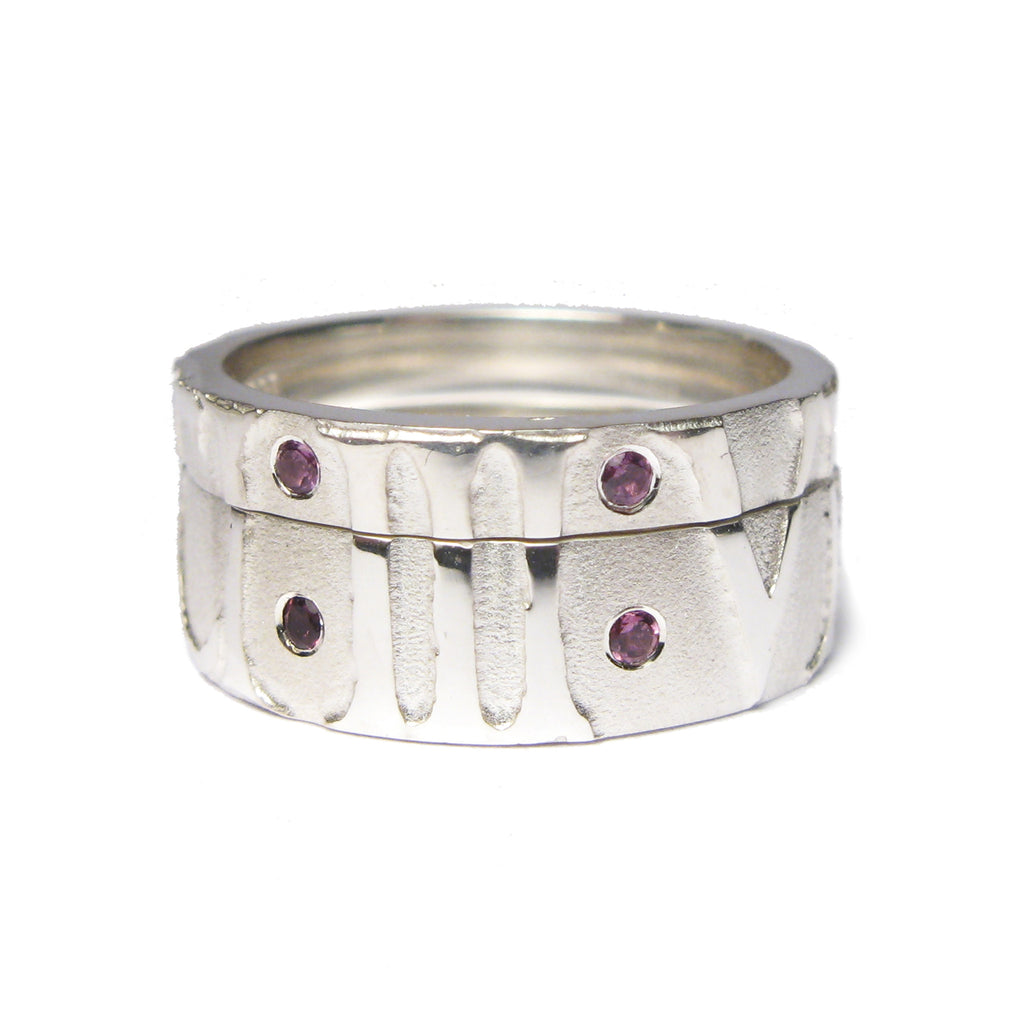 Diana Porter Contemporary jewellery Bespoke silver partnership rings with relief etching and garnets.