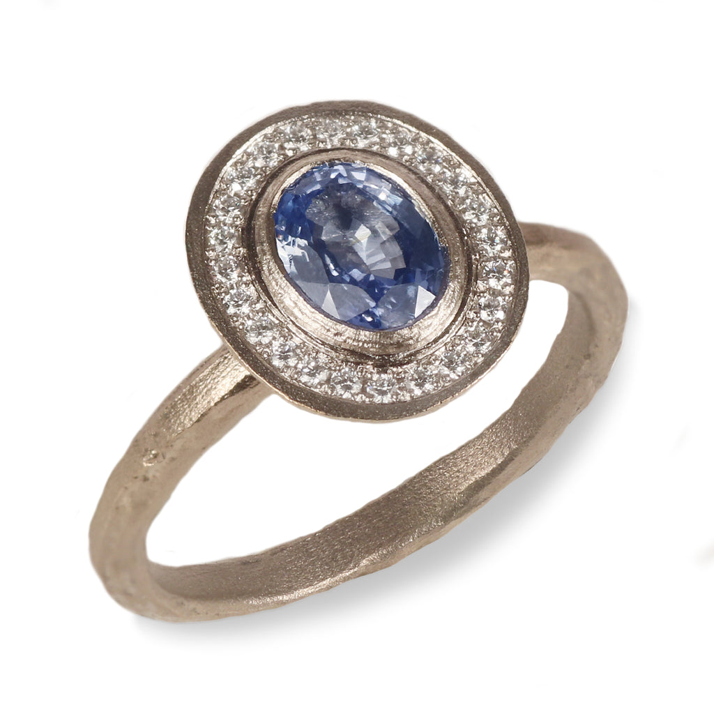 White Gold Oval Shaped Blue Sapphire and Diamond Halo Ring  on white background