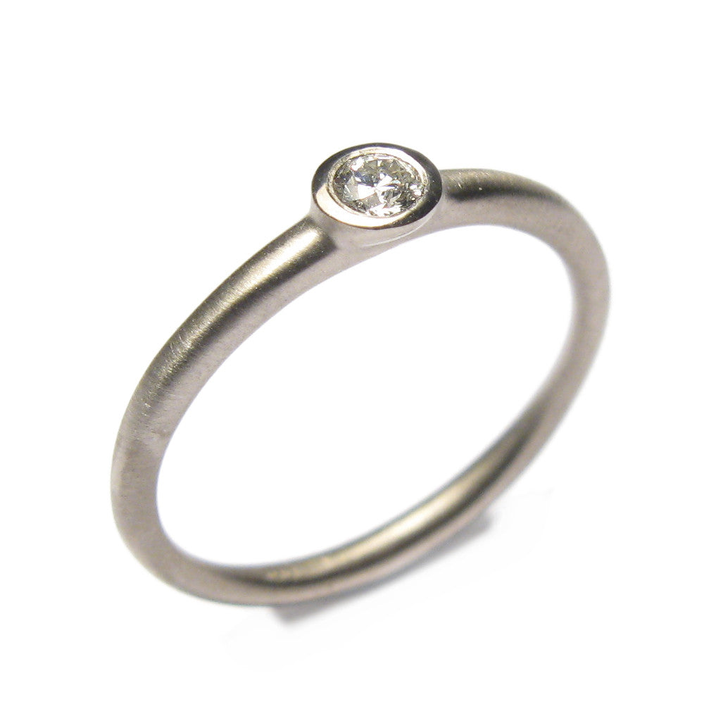 Modern White Gold Ring with Solitaire Diamond  on white background 