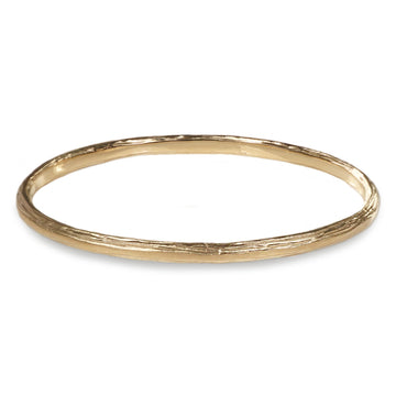 A 9ct Fairtrade yellow gold bangle with a textured etched finish.