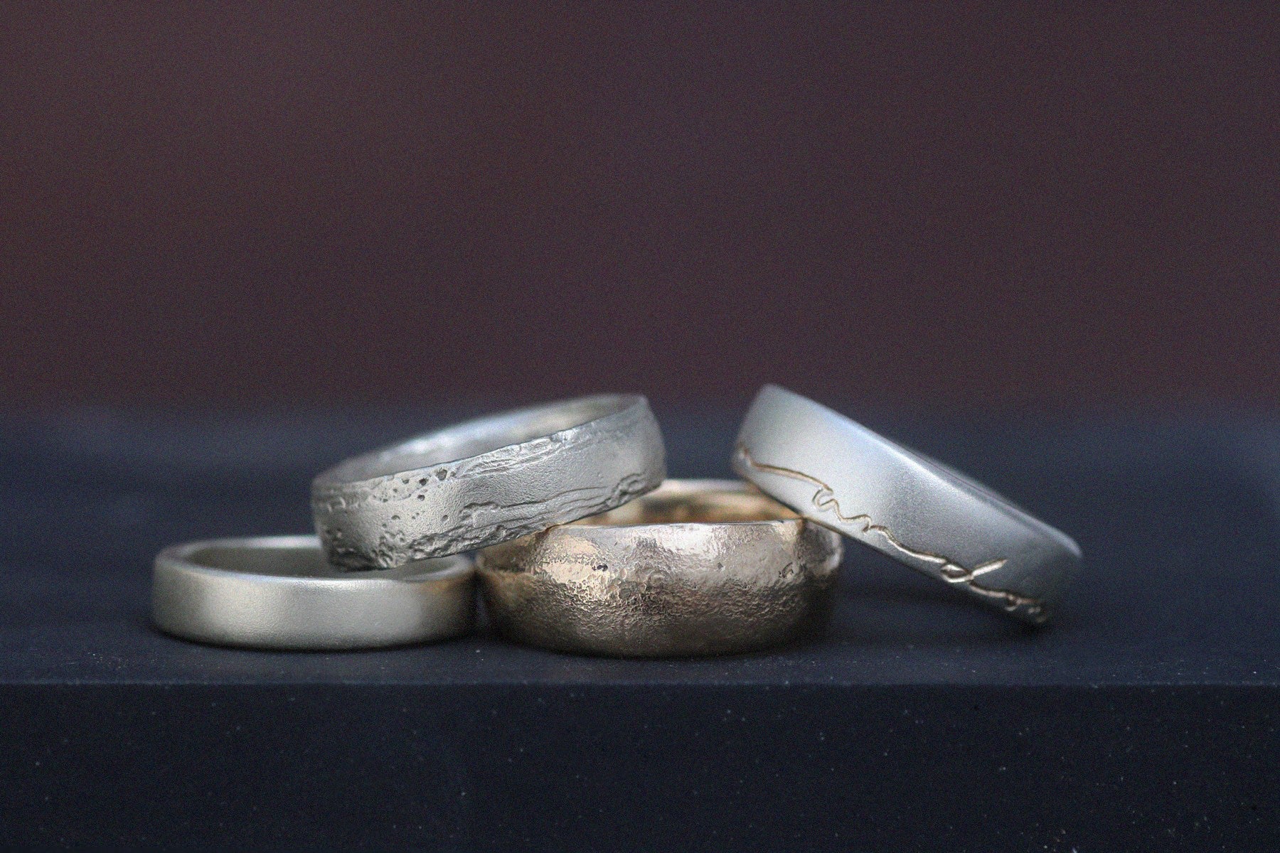 a selection of men's engagement rings in silver, gold and platinum