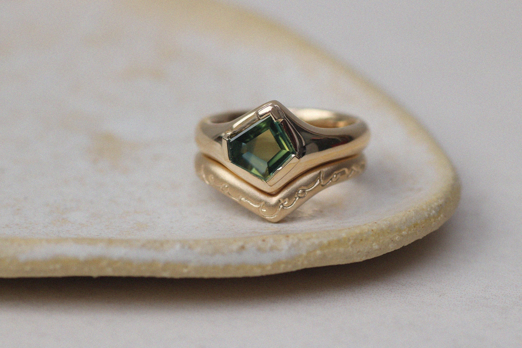 A contemporary gold ring with green emerald