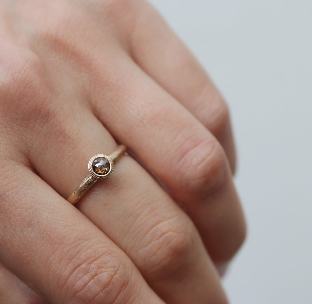 Textured Yellow Gold Ring with Brown Rose Cut Diamond worn on hands 