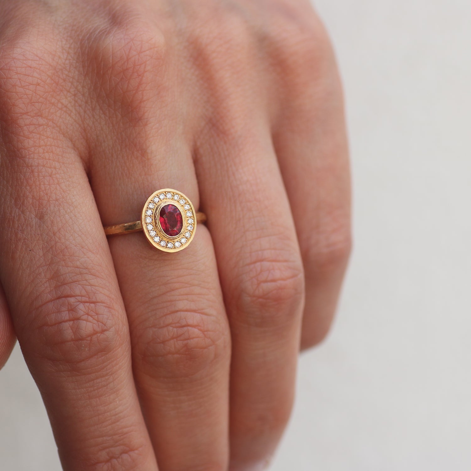 Yellow Gold Oval Shaped Ruby and Diamond Halo Ring