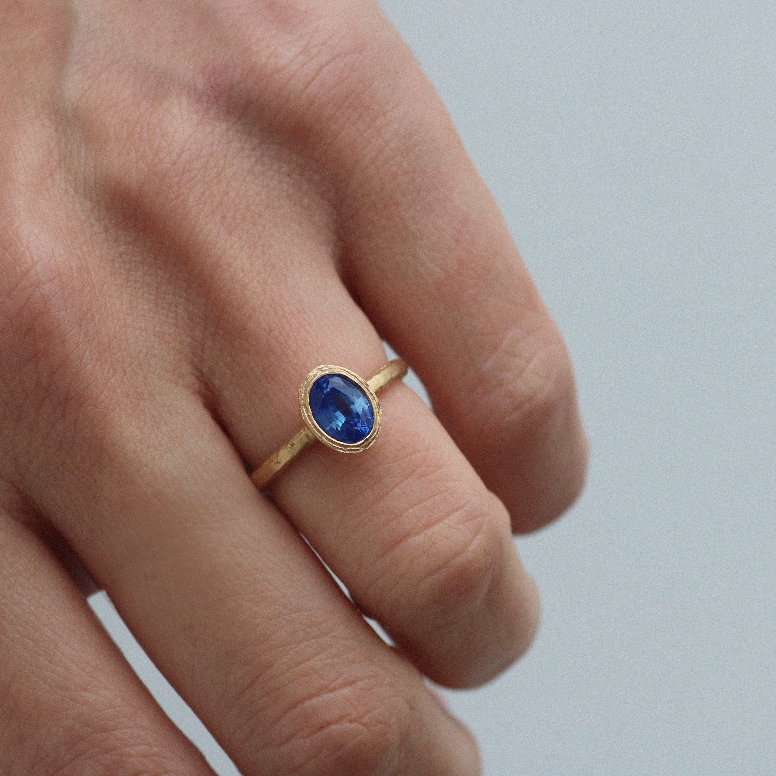 Oval Blue Sapphire and Textured Yellow Gold Solitaire Ring