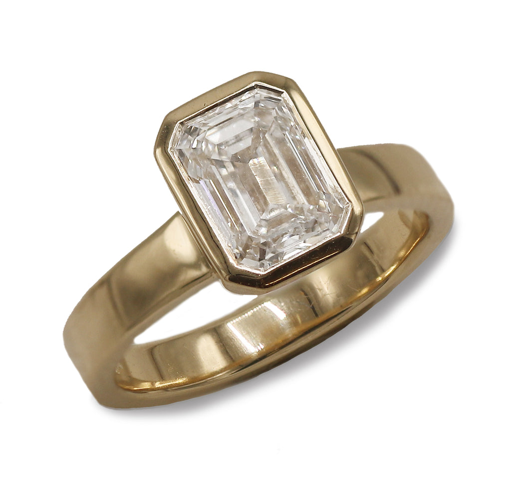 9ct Yellow Gold Ring With Lab Grown Emerald Cut Diamond on a white background. 