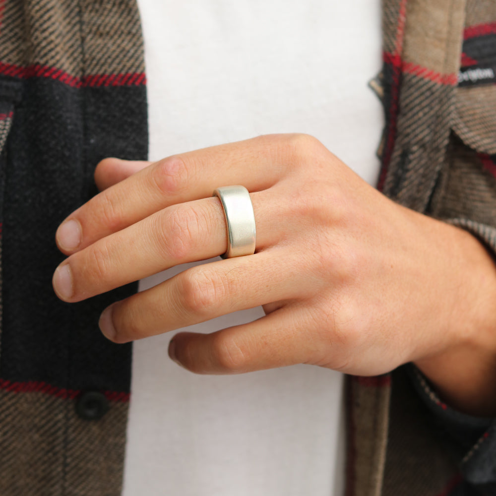 A chunky silver ring by Diana Porter Jewellery being worn by a male on his middle finger