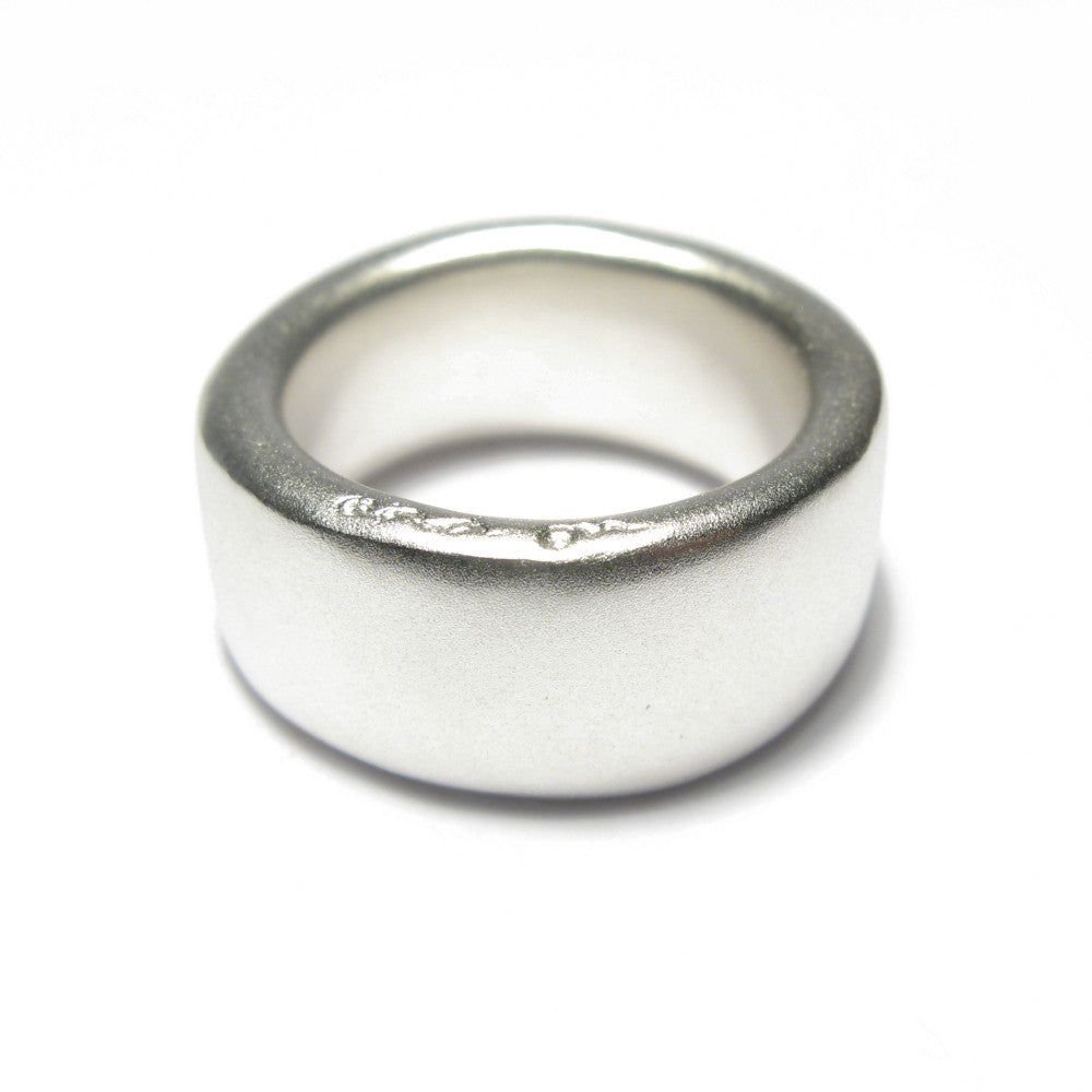 Wide plain silver band ring displayed on a white background
