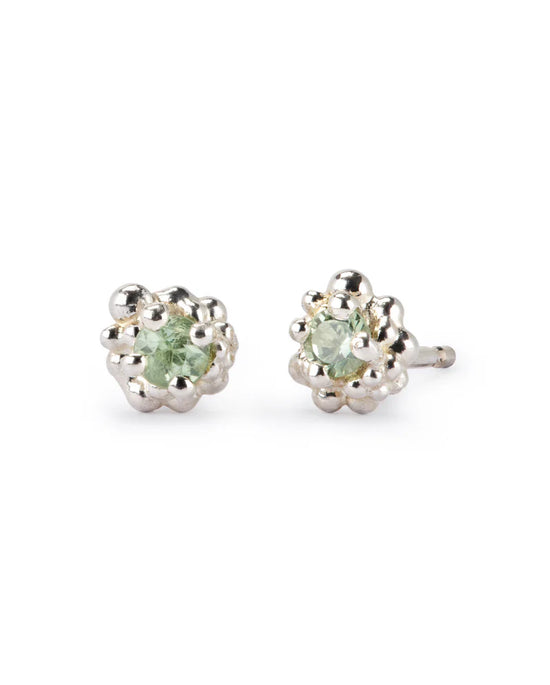 Pair of silver earrings with green gemstones on a white background