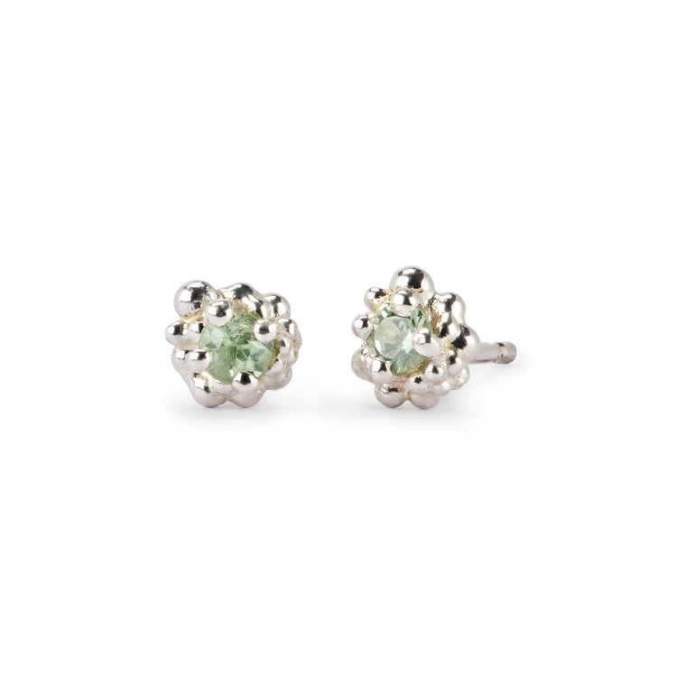 Pair of silver earrings with green gemstones on a white background