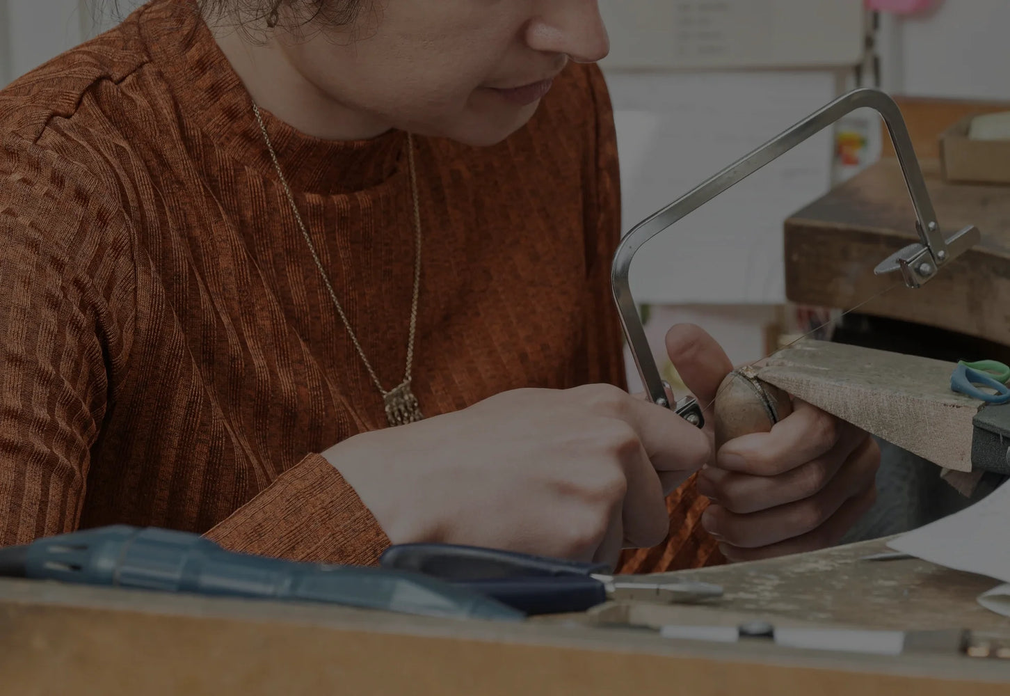 A skilled artisan creating contemporary jewellery in a workshop