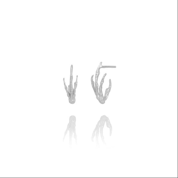 A pair of silver-toned coral stud earrings with a textured, organic bird foot design, shown against a solid white background with a soft reflection below.