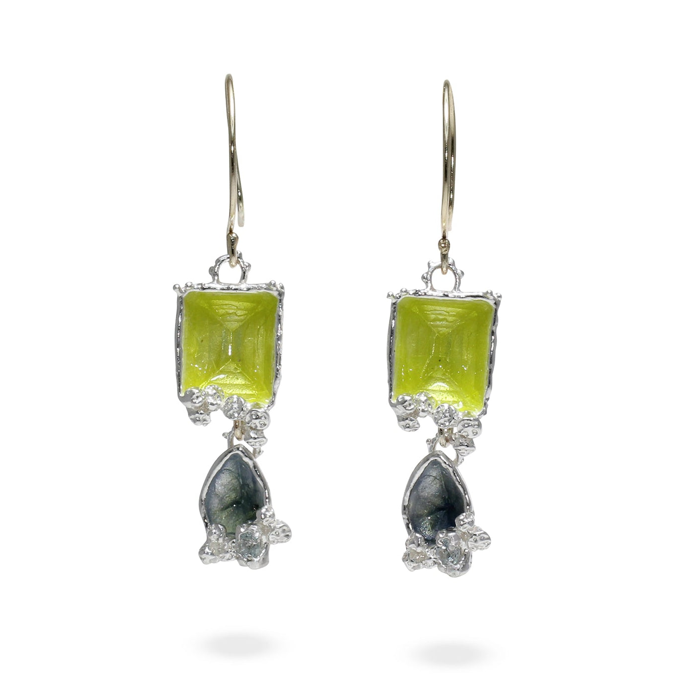 Pair of earrings with green gemstones on a white background