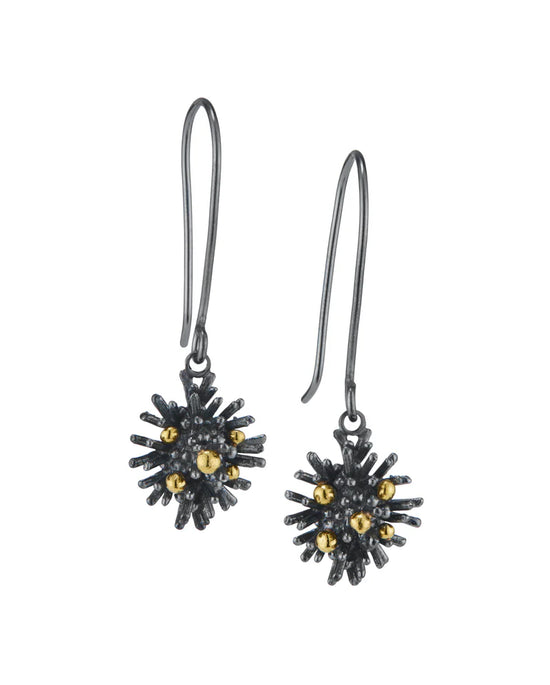 Pair of black and gold earrings on a white background