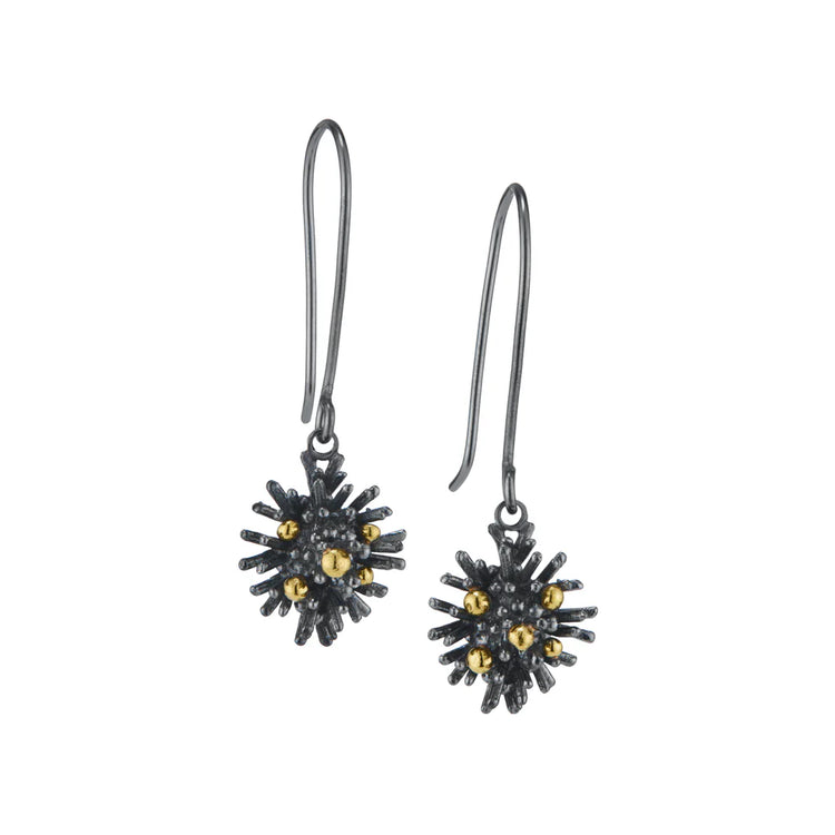Pair of black and gold earrings on a white background