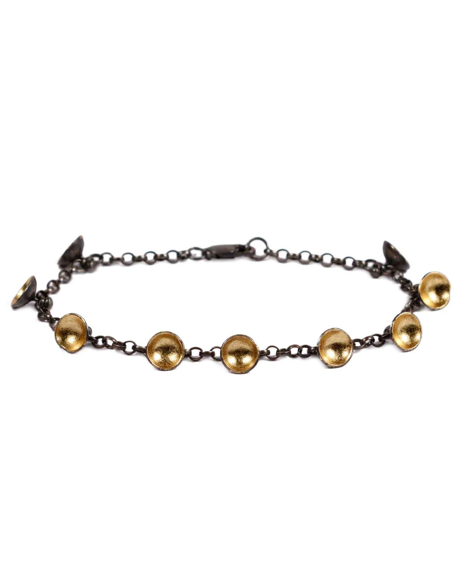 black chain bracelet with black and gold pods on white background