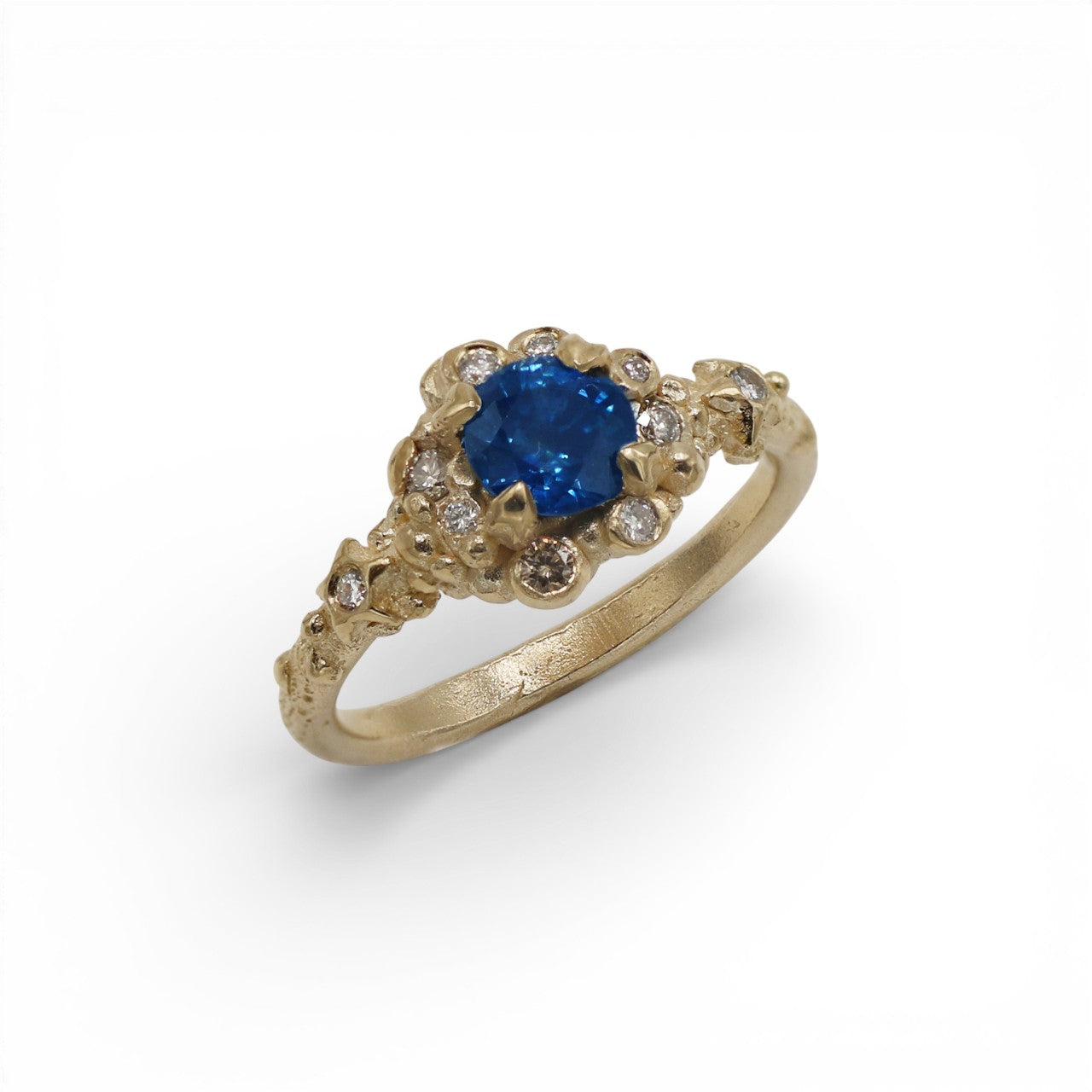 Blue Sapphire yellow gold ring on a white background