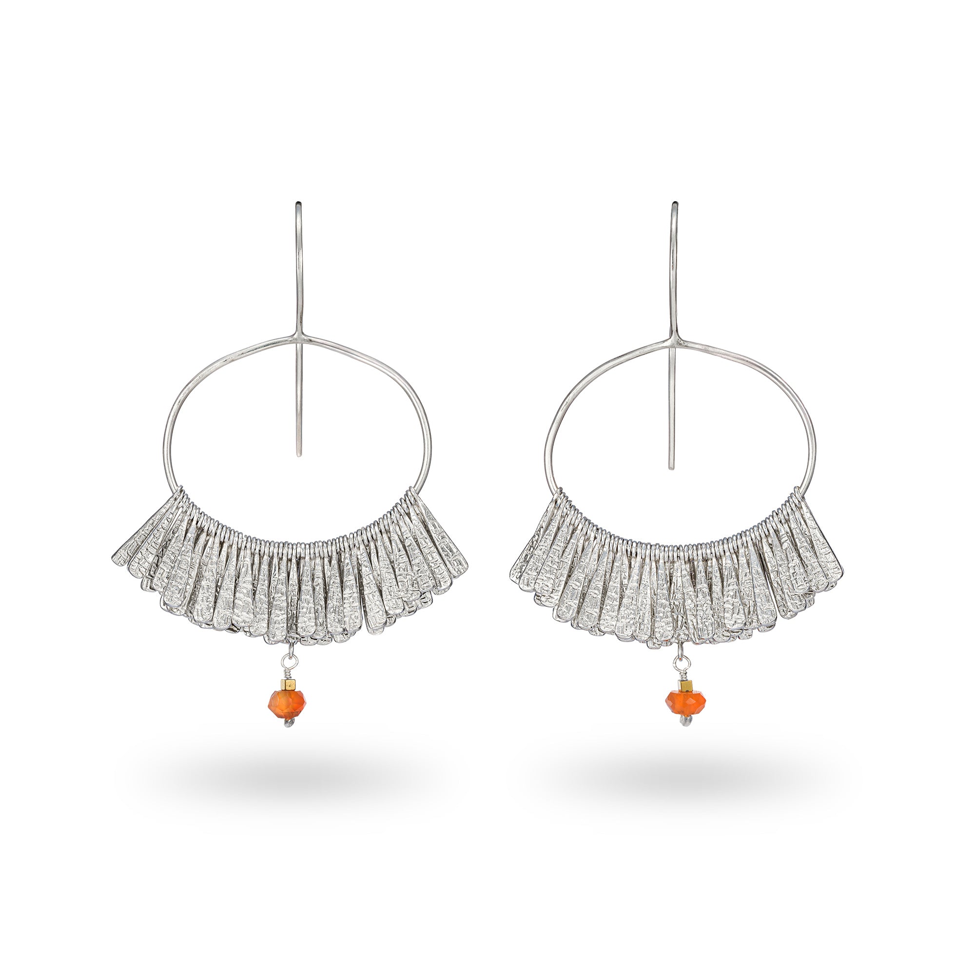 Pair of silver hoop earrings with fringe and orange beads on a white background