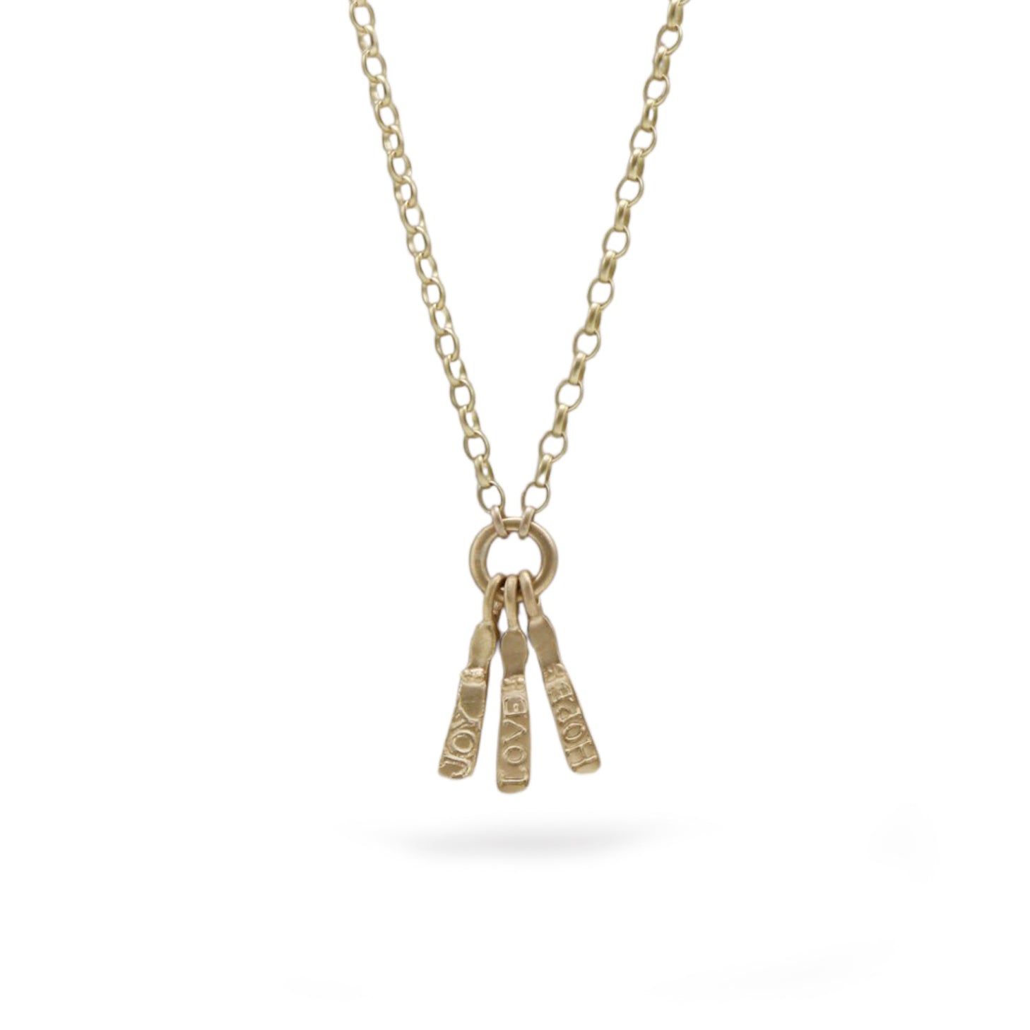 A gold chain necklace with a ring pendant holding three small textured bar charms engraved with 'JOY', 'GOOD', and 'TIME', shown on a white background.