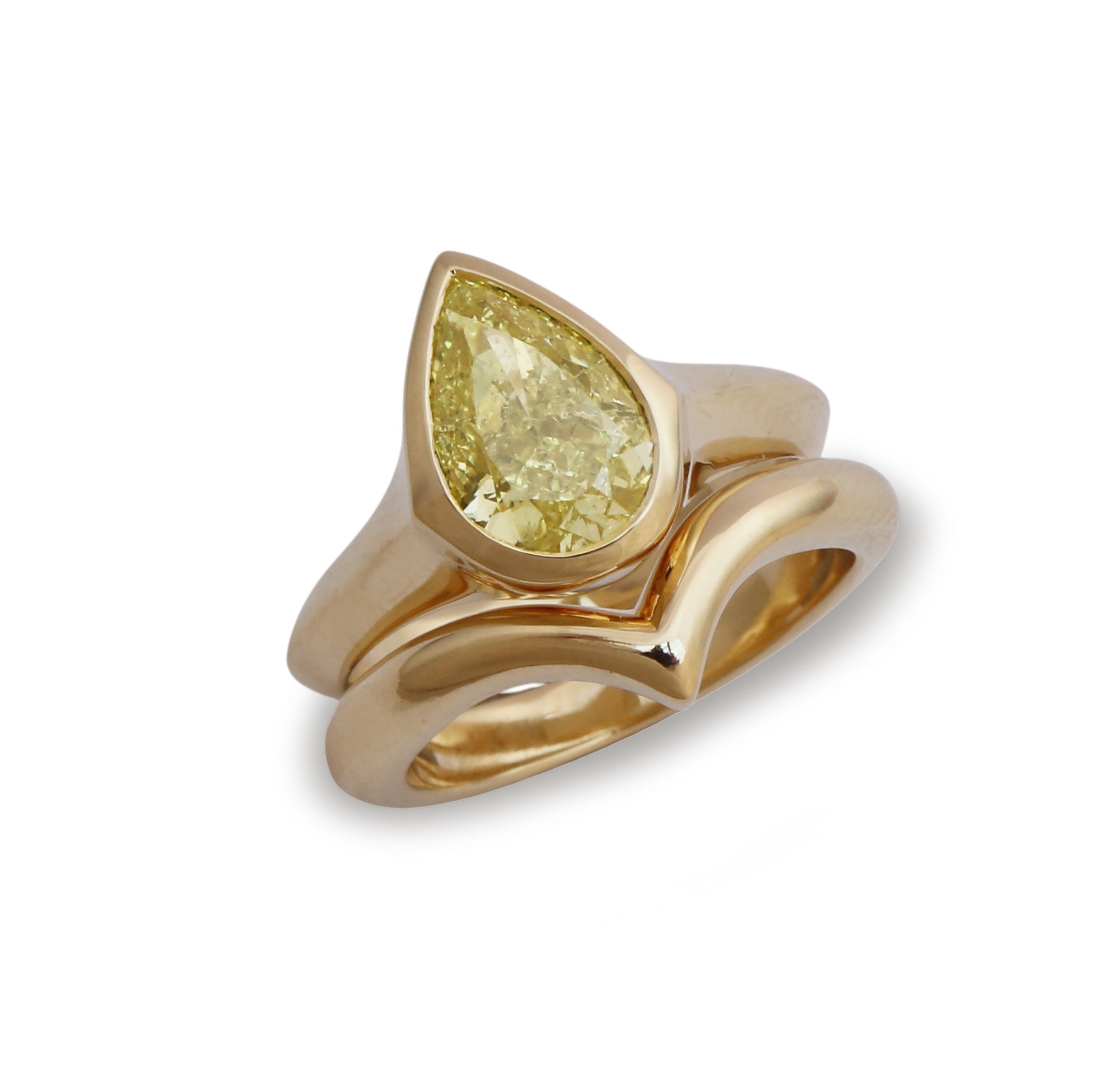 A yellow gold ring featuring a large pear-cut diamond center stone, set against a clean white background.