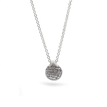 silver pebble pendant with words on white background 