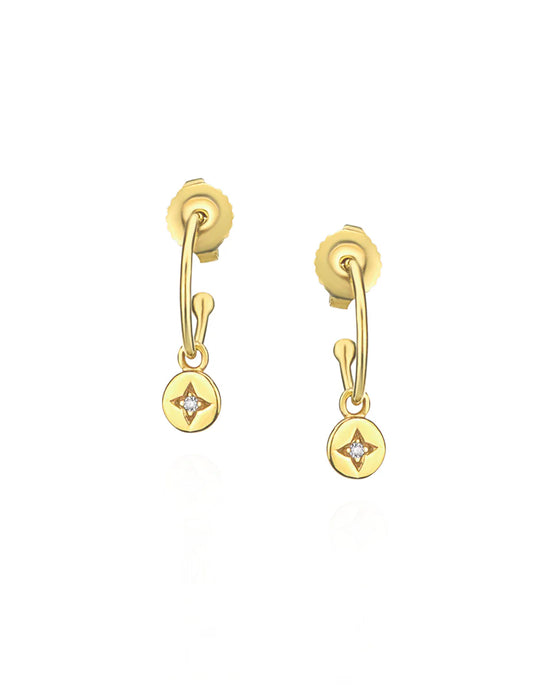 Gold earrings with small diamond-like stones on a white background
