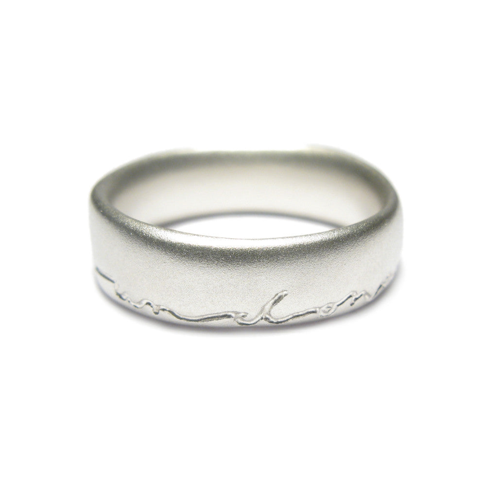 Silver wedding ring with 'and on' etched in silver. Displayed on a white background