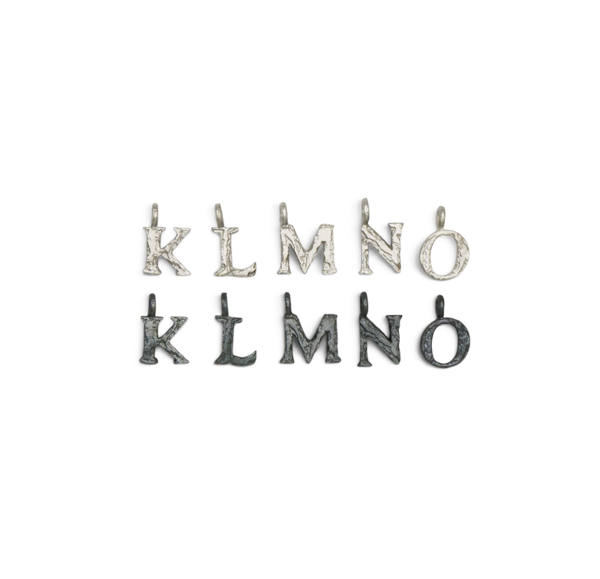 Silver Letter charms from K - O on a white background 
