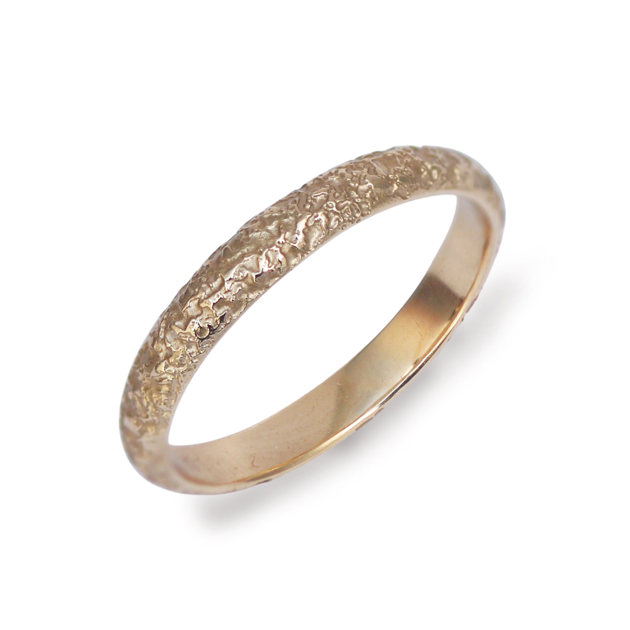 A textured yellow gold wedding ring with a subtle dome shape on a white background. 