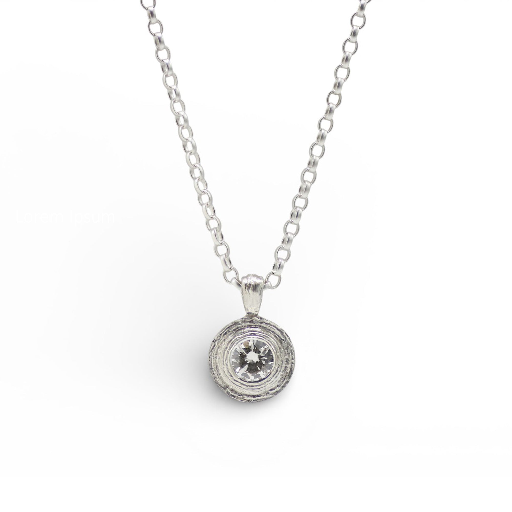A white gold chain necklace with a round pendant featuring a clear central gemstone surrounded by a textured silver halo, shown on a plain white background.