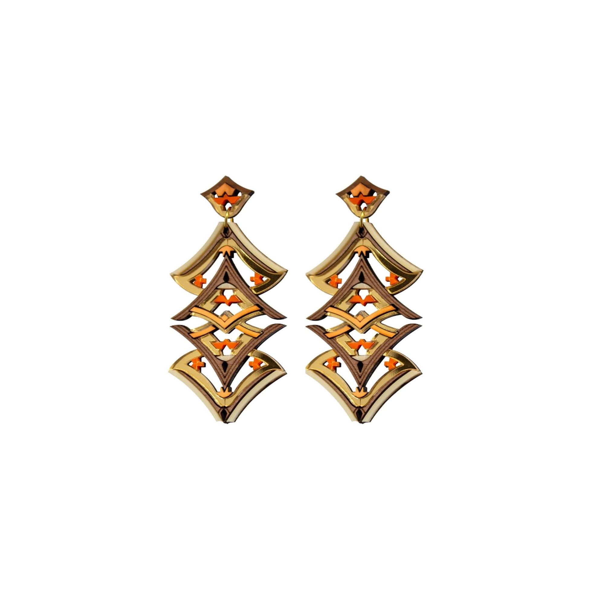Pair of gold and orange earrings on a white background
