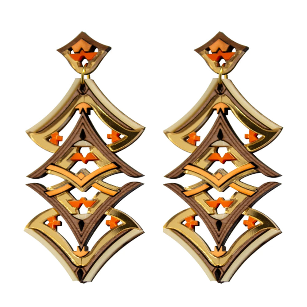 Pair of gold and orange earrings on a white background