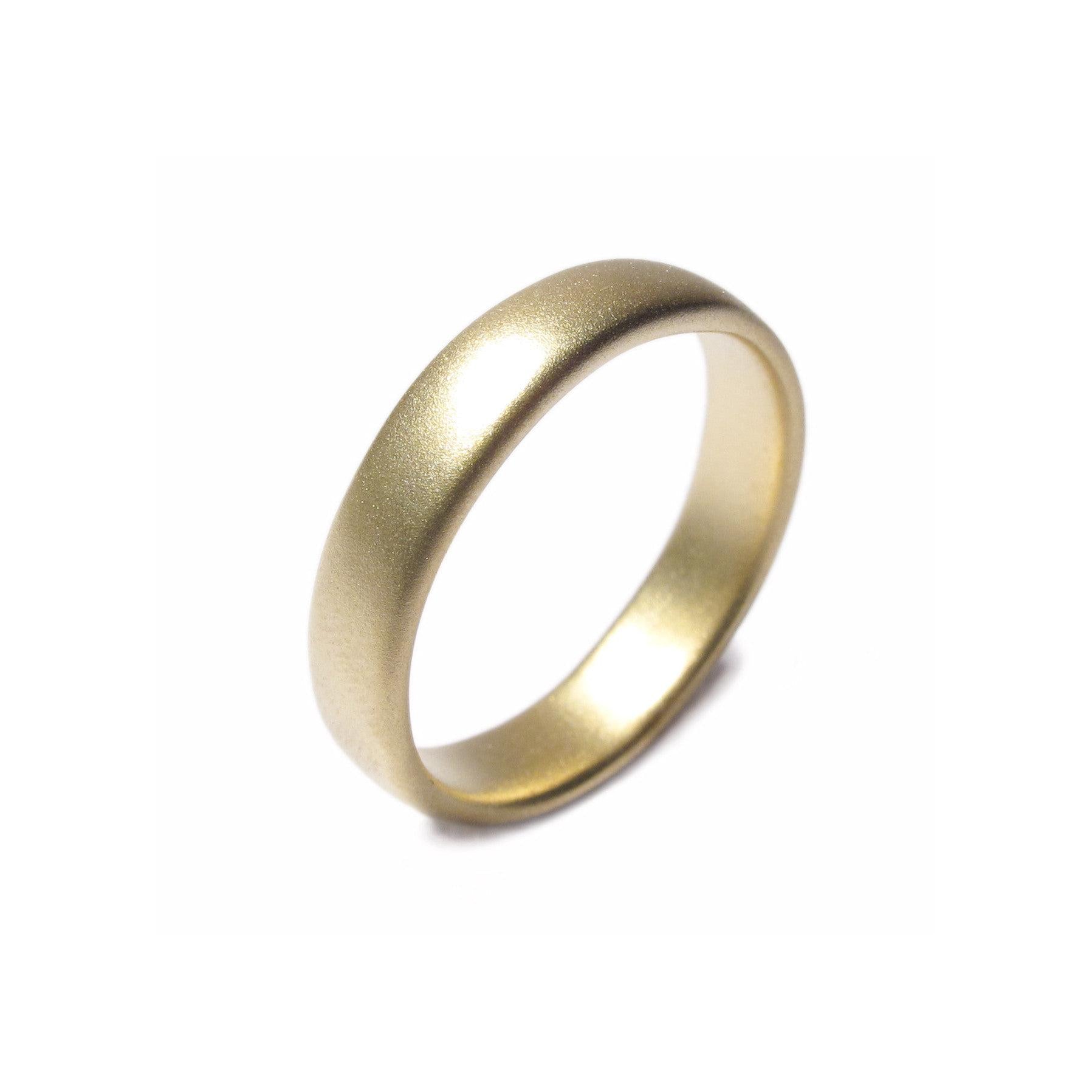 A plain 18ct Fairtrade Yellow Gold wedding ring displayed on a white background