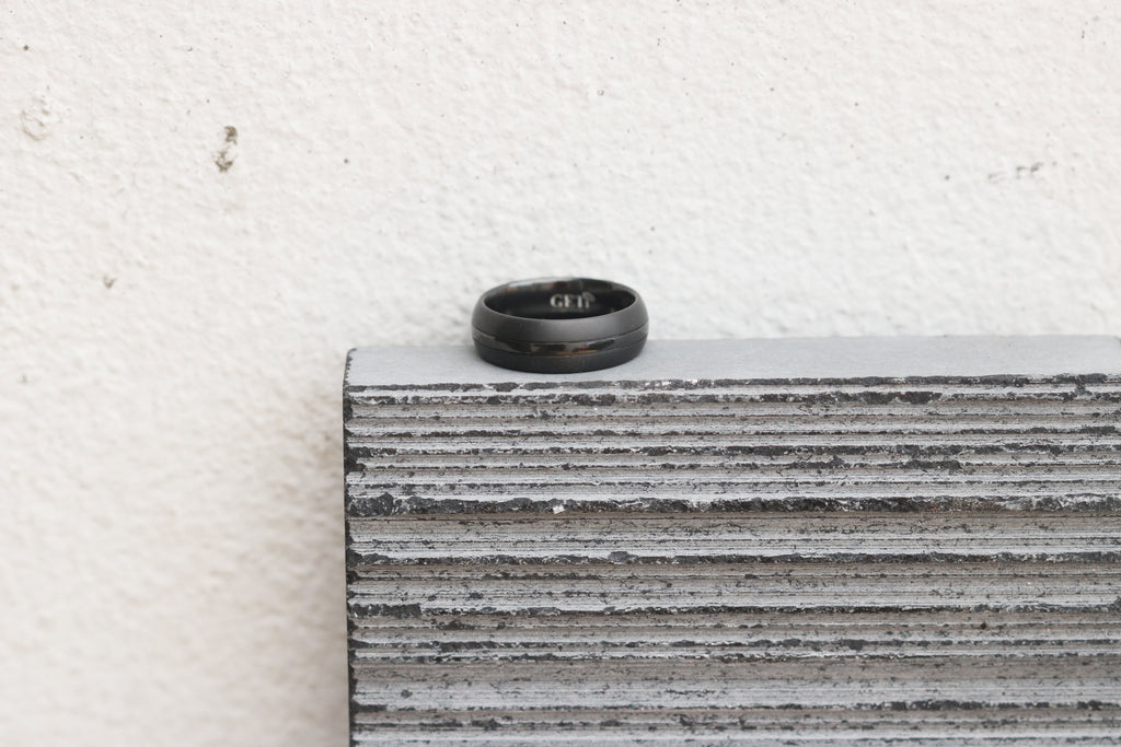Black ring on a textured stone surface