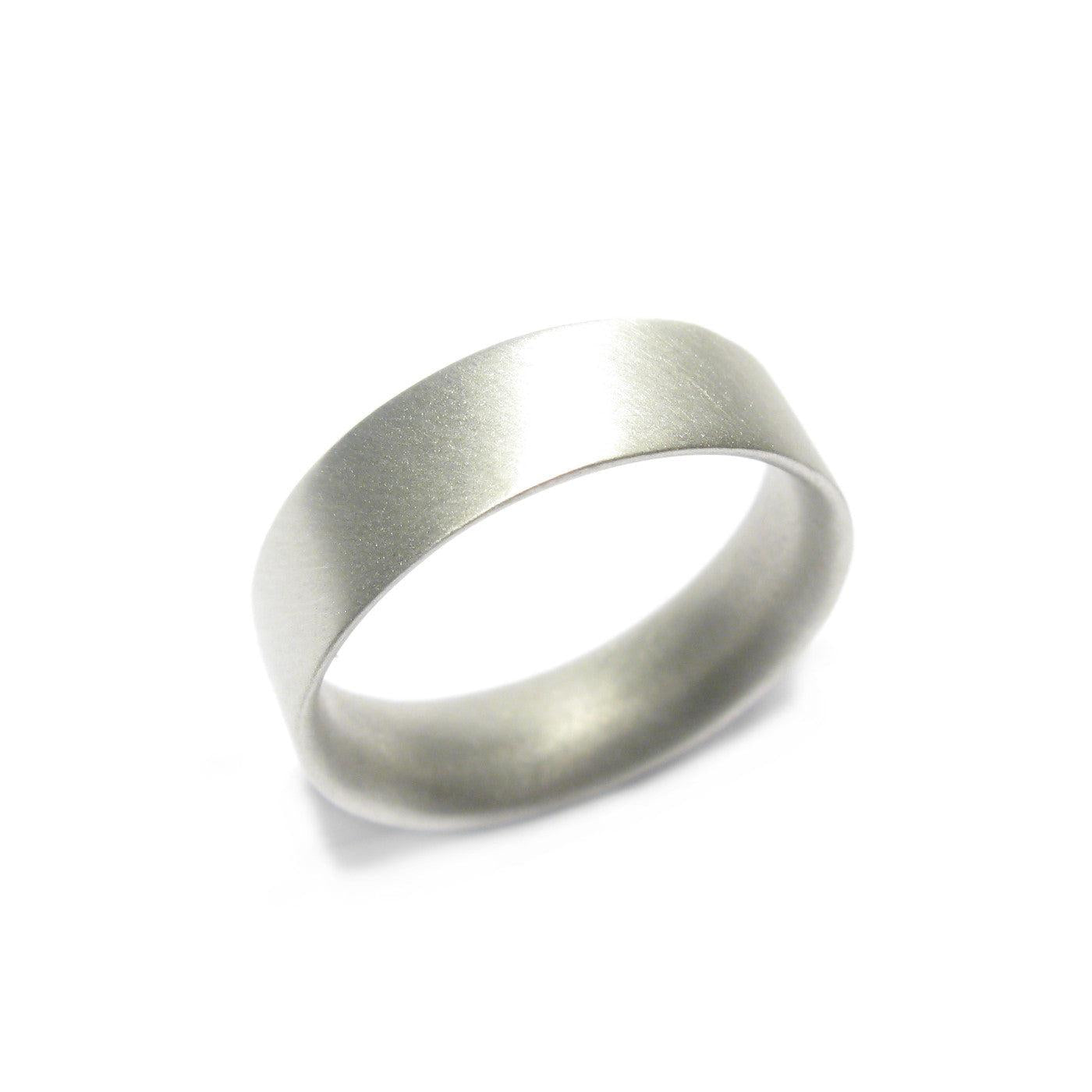 Wide, men's 9ct white gold ring displayed on white background